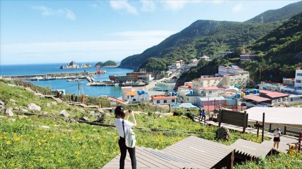 홍도 선착장에 홍도원추리를 배경으로 그리스 산토리니를 연상케 하는 마을이 들어서 있다. /신안군 제공