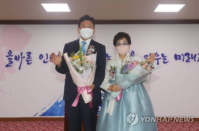 꽃다발 받은 김광수 제주교육감 (제주=연합뉴스) 전지혜 기자 = 1일 제주도교육청 대회의실에서 열린 김광수 제주도교육감 취임식에서 김 교육감이 축하 꽃다발을 받은 뒤 기념촬영하고 있다. 김 교육감 오른쪽은 부인인 김순선 여사. 2022.7.1 atoz@yna.co.kr