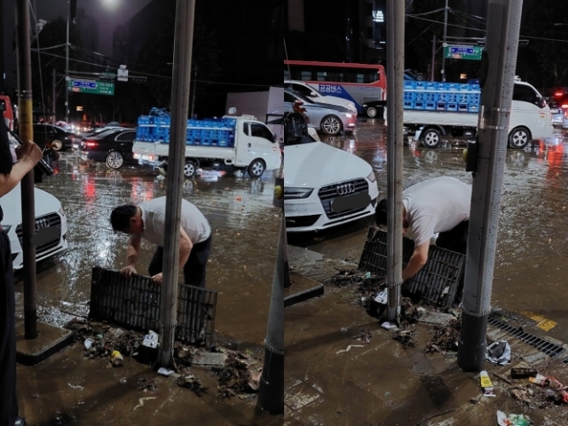 폭우로 서울 강남역 인근 도로가 침수된 가운데 한 시민이 물과 쓰레기로 막힌 도로 내 배수관을 맨손으로 정리하는 모습이 포착됐다. 그에게는 '강남역 슈퍼맨'이라는 별명이 붙었다. 온라인 커뮤니티 캡처