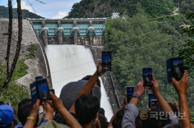 11일 강원도 춘천 소양강댐 인근 신샘밭로에서 시민들이 휴대폰을 손에 들고 촬영하고 있다.