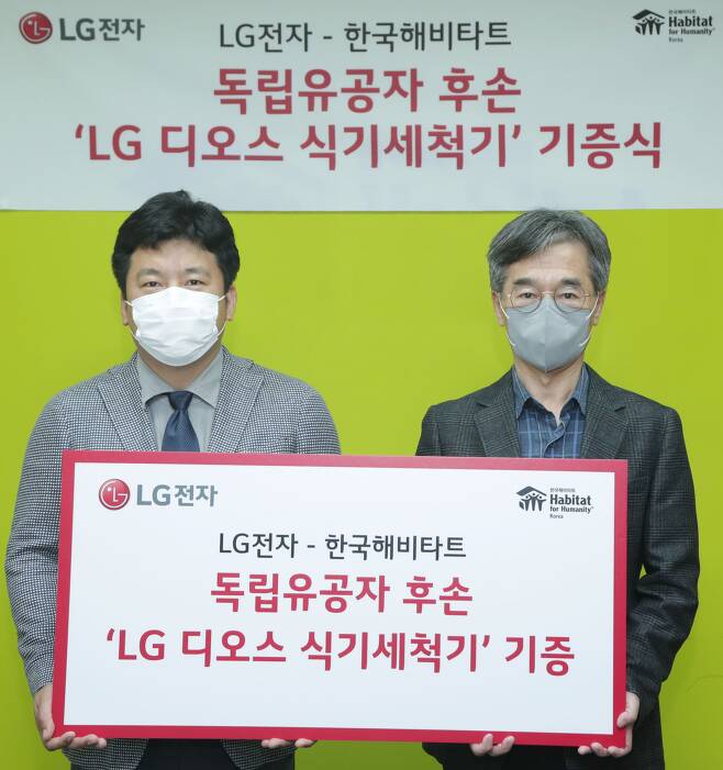 윤성일 LG전자 키친어플라이언스마케팅담당 상무(왼쪽)와 이광희 한국해비타트 사무총장이 ‘LG 디오스 식기세척기 기증식’에서 기념촬영을 하고 있다. /LG전자