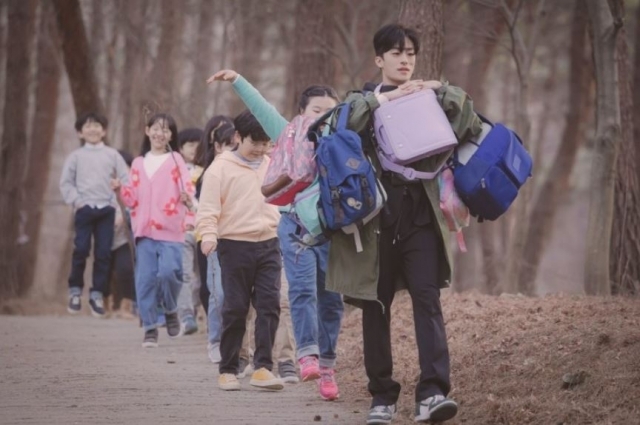 드라마 ‘이상한 변호사 우영우’에서 방구뽕 역할의 배우 구교환이 어린이들과 함께 놀이를 하러 산으로 향하는 장면. ENA 제공