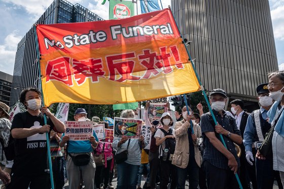 장례식이 열린 일본 도쿄 무도관 앞에서 27일 반대 시위를 벌이는 시민들. AFP=연합뉴스
