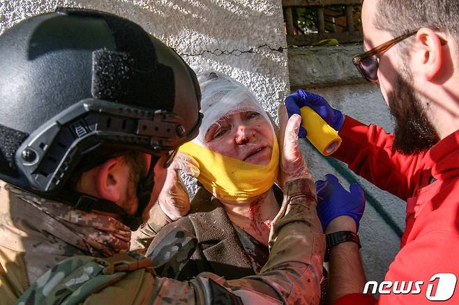 10일(현지시간) 오전 8시경 우크라이나 수도 키이우에서 한 시민이 러시아의 미사일 공습으로 부상을 입고 응급 조치를 받고 있다. 2022.10.10 ⓒ 로이터=뉴스1 ⓒ News1 정윤미 기자