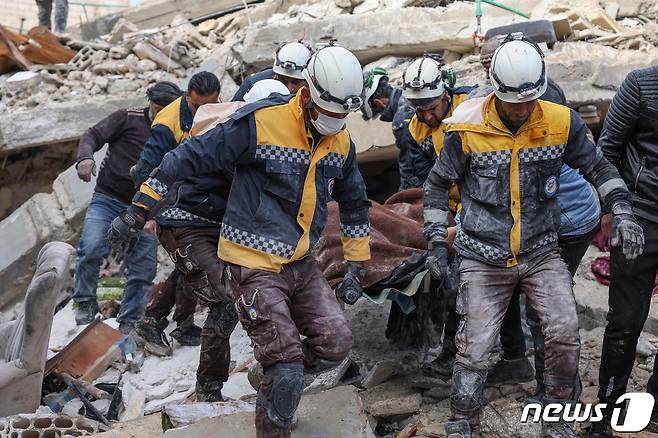 7일(현지시간) 시리아 민방위대인 '하얀 헬멧'이 시리아 반군 장악 지역인 이들리브에서 지진 희생자를 이송하고 있다. 23.02.07 ⓒ AFP=뉴스1 ⓒ News1 김예슬 기자
