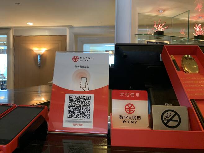 중국 베이징 왕푸징의 그랜드하얏트 호텔 카운터에 디지털 위안화(e-CNY) 사용을 환영한다는 안내판이 설치돼 있다. /베이징=김남희 특파원
