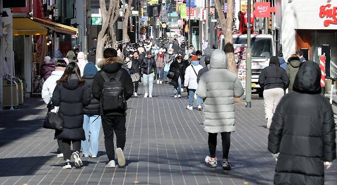 24일 오후 서울 중구 명동거리를 찾은 시민들이 외투 모자를 쓰며 걷고 있다. / 뉴스1