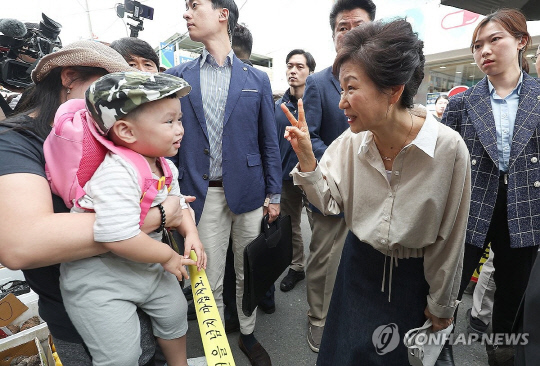 박근혜 전 대통령이 25일 대구 달성군 현풍시장을 찾아 시민들과 인사하고 있다. 연합뉴스