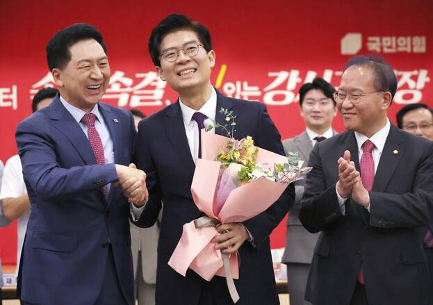지난 21일 서울 강서구 문화복지센터에서 열린 국민의힘 동행 서약식에서 김기현 대표가 합당을 선언한 조정훈 시대전환 의원과 악수를 하고 있다. 연합뉴스