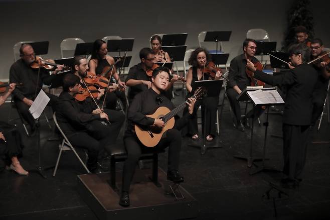 Deion Cho (center) plays the guitar at the 56th Francisco Tarrega International Guitar Competition in Spain. (Courtesy of Deion Cho)