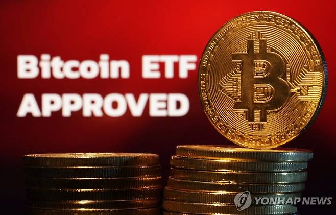 Representation of Bitcoin cryptocurrency and "Bitcoin ETF Approved" words are seen in this illustration taken January 11, 2024. REUTERS/Dado Ruvic/Illustration