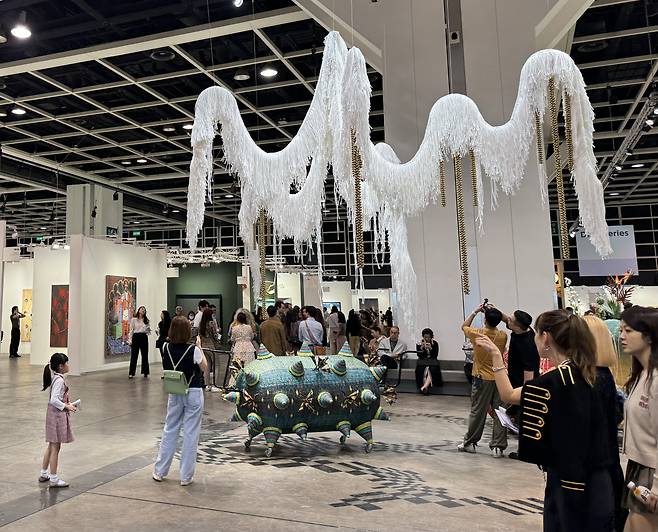Visitors view an installation titled "Contingent Spheres (2020, 2022)" by South Korean artist Yang Hae-gue, at the Art Basel in Hong Kong on Tuesday. (Park Ga-young/The Korea Herald)