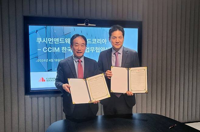 민흥식 CCIM한국협회 회장(왼쪽)과 황점상 쿠시먼앤드웨이크필드 코리아 대표(오른쪽)가 업무협약을 맺고 있다.
