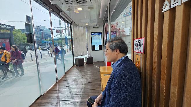 서울 성동구 버스정류장에 설치된 히어링루프를 이용하는 난청인 김재호씨. 하지만 안내 방송의 음량이 너무 작거나 커서 결국 김씨는 이날 히어링 루프의 도움을 받기를 포기했다. 나채영 기자