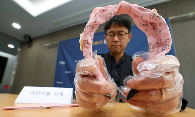 서울시 관계자가 16일 서울 중구 서울시청에서 인체발암 가능 물질인 프탈레이트계 가소제가 검출된 해외 직구 어린이용 머리띠를 들어 보이고 있다. 정부는 어린이제품·전기·생활용품 등 80종에 대해 안전 인증 없는 경우 해외 직구를 금지하기로 했다. 연합뉴스