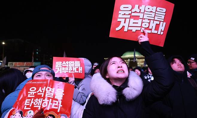 7일 저녁 ‘윤석열 대통령 탄핵소추안’이 정족수 미달로 자동 폐기되자 서울 여의도 국회 앞에 있던 한 시민이 국민의힘 의원들에게 소리치고 있다. 김혜윤 기자 unique@hani.co.kr