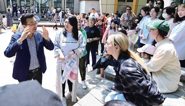 함박마을 고려인 바자회 참석자들이 이재호 인천 연수구청장(왼쪽)과 대화하며 물품 판매를 준비 중이다. 연수구 제공