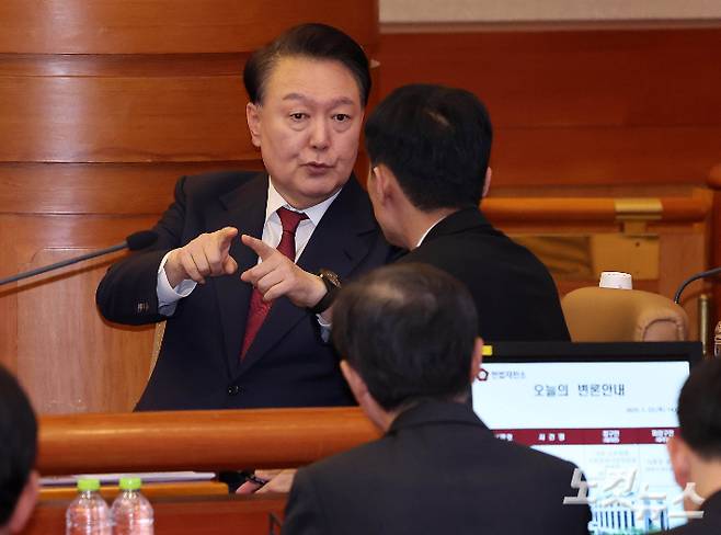 윤석열 대통령이 23일 서울 종로구 헌법재판소에서 열린 탄핵심판 4차 변론에 출석해 변호인단과 대화를 나누고 있다. 사진공동취재단