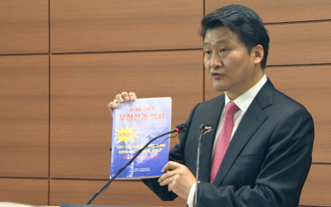 2014년 4월3일 윤옹걸 당시 차장검사가 서초동 고검 기자실에서 열린 18대 대선 부정선거백서 저자 및 법정난동 사법 구속 기소 브리핑에서 ‘부정선거 백서’를 들어보이고 있다. 연합뉴스