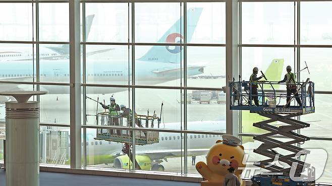 인천공항운영서비스 환경미화운영그룹 직원들이 25일 오전 인천국제공항 제2터미널에서 봄맞이 유리창 물청소를 하고 있다. 2025.3.25/뉴스1 ⓒ News1 장수영 기자