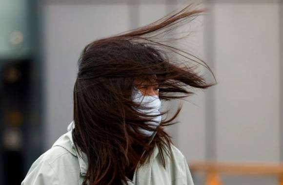 지난 주말 중국 수도 베이징에서 한 여성이 강풍을 맞고 있다. 로이터 연합뉴스