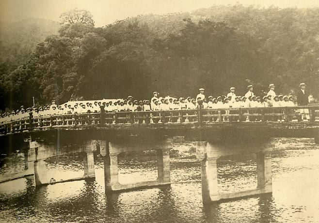 1920년대 전주 신흥학교 학생들이 전주서문교회 주일 예배에 참석하기 위해 줄지어 다리를 건너는 모습. /전주서문교회