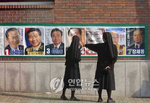 제16대 대선 선거 벽보 16대 대통령 선거 벽보가 나붙은 2일 오후 서울 가회동의 한 거리에서 길을 지나던 수녀들이 선거 벽보를 보고 있다. /성연재/정치/ 2002.12.2 (서울=연합뉴스) paparazzo@yna.co.kr <저작권자 ⓒ 2002 연합뉴스. 무단전재-재배포 금지.>