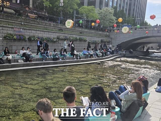2일 오후 서울야외도서관 책읽는 맑은냇가. '그린 오로라' 의자 위에 앉아서 책읽는 시민들./설상미 기자