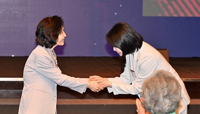 김문수 국민의힘 대선 후보 부인 설난영 씨(왼쪽)와 이재명 더불어민주당 대선 후보 부인 김혜경 씨가 12일 오후 서울 중구 신라호텔에서 열린 조계종 중앙신도회 창립 70주년 기념식에서 손을 맞잡고 있다. 임세준 기자