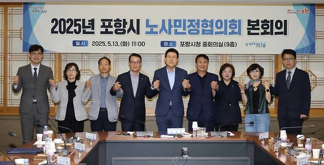 이강덕 시장(가운데)이 노사민정협의회 본회의 참석자들과 손을 맞잡고 기념촬영을 하고 있다. 포항시 제공