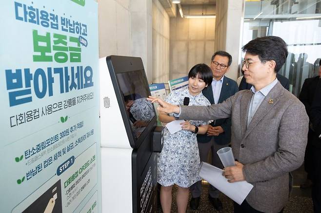 김완섭 환경부장관이 19일 강원도 강릉시 소재 한 카페에서 ‘강릉시 맞춤형 다회용 컵 보증금제 시행을 위한 자발적 협약’을 체결하고 무인 회수기를 통한 다회용 컵 반납을 시연하고 있다. 환경부 제공.