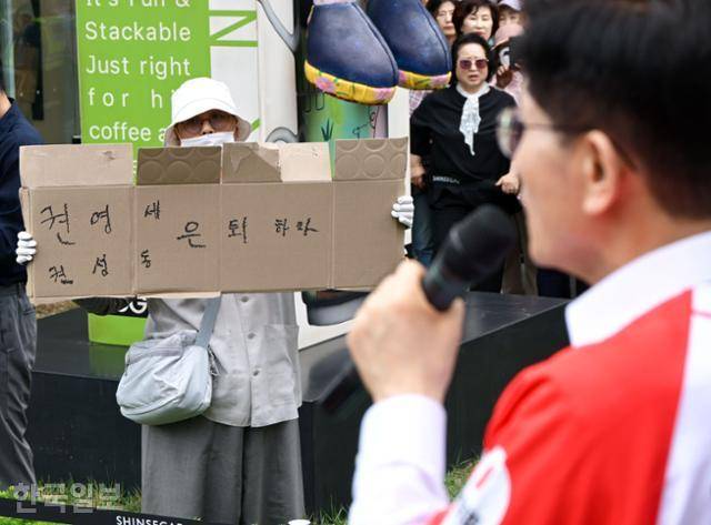 김문수(오른쪽) 국민의힘 대선 후보가 16일 충남 천안시 동남구 신세계백화점 앞에서 유세 발언을 하고 있는 가운데, 한 시민이 '권영세·권성동 은퇴하라'라는 문구를 적은 종이박스를 들어 보이고 있다. 천안=하상윤 기자