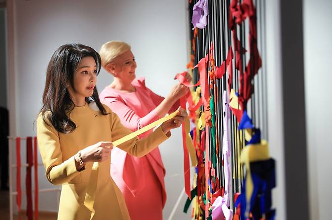 윤석열 전 대통령과 폴란드를 공식 방문한 김건희 여사가 2023년 7월13일(현지시간) 바르샤바의 와지엔키 박물관에서 프리다 칼로의 시그니처 색상을 사용해 리본을 구성하는 체험을 하고 있다. 대통령실 제공