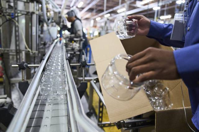 미국 조지아주 디케이터에 있는 한 제조업체에서 근로자들이 플라스틱 용기를 컨베이어 벨트 위에 올려놓고 있다. AP연합뉴스