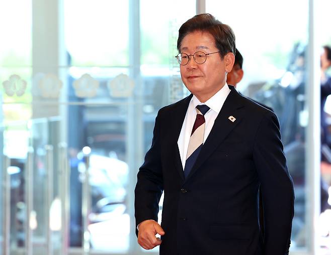 President Lee Jae-myung enters the presidential office in Yongsan, Seoul, on Wednesday. (Yonhap)