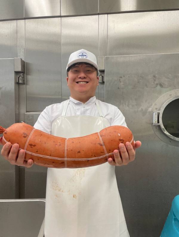 박가정 '박지원' 대표가 IFFA 2025 출품을 위해 직접 제작한 '의성마늘 약트부어스트'를 들고 있다. 박가정