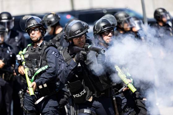 현지시간 8일 캘리포니아주 로스앤젤레스 연방 건물 밖에서 경찰이 시위대를 향해 비살상용 탄을 발사하고 있다. AFP=연합뉴스