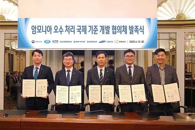 지난 13일 서울에서 열린 ‘암모니아 연료추진선 오수 해양배출 기준 마련 협의체’ 출범식에서 한국선급과 국내 조선 5사, 한국화학융합시험연구원 관계자들이 기념촬영을 하고 있다. 왼쪽부터 한화오션 최영환 팀장, KTR 김태성 본부장, KR 김경복 부사장, HD한국조선해양 박상민 부문장, 삼성중공업 양준 그룹장/ 사진=한국선급 제공
