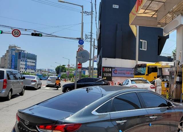 정부가 유류세 인하를 8월 말까지 2개월 추가 연장하기로 한 가운데, 18일 오후 대구 북구의 한 알뜰주유소를 찾은 시민들이 줄을 선 채 순서를 기다리고 있다. 권영진 기자