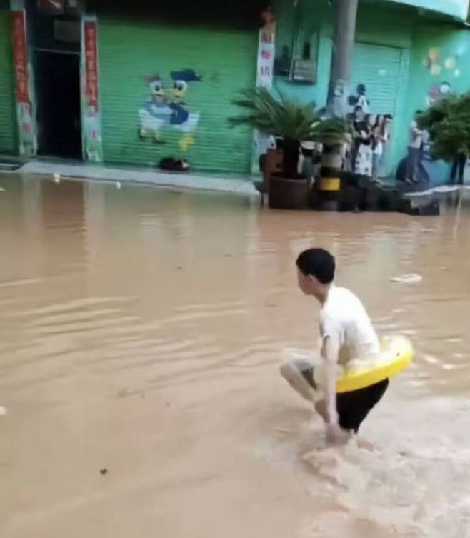 폭우에 한 학생이 튜브를 타고 학교에 도착했다. 웨이보.