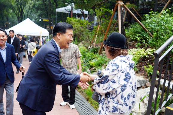 이승로(왼쪽) 서울 성북구청장이 지난 16일 열린 ‘오동 물빛정원’ 준공식에서 만난 지역 주민과 대화를 나누고 있다. 성북구 제공