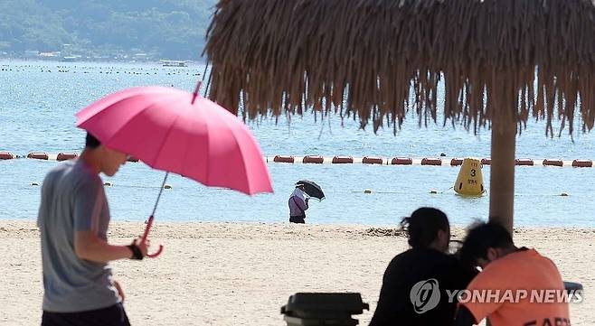 무더운 여름 양산 아래 (창원=연합뉴스) 김동민 기자 = 전국적으로 무더위가 이어진 30일 오후 경남 창원시 마산합포구 광암해수욕장에서 관광객들이 양산 등을 챙겨 이동하고 있다. 2025.6.30 image@yna.co.kr