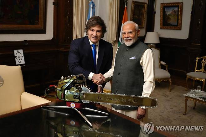 밀레이 아르헨티나 대통령(좌)과 모디 인도 총리(우) (부에노스아이레스=AFP 연합뉴스) 5일(현지시간) 아르헨티나 부에노스아이레스의 대통령궁 카사 로사다에서 열린 아르헨티나-인도 정상회담에서 하비에르 밀레이 아르헨티나 대통령과 나렌드라 모디 인도 총리가 전기톱 뒤에서 포즈를 취하고 있다. 모디 총리는 브라질 리우데자네이루에서 열리는 브릭스(BRICS) 정상회의에 참석하기 위해 브라질로 향하기 전에 아르헨티나를 방문해 밀레이 대통령과 양자 회담을 가졌다. 2025.7.6