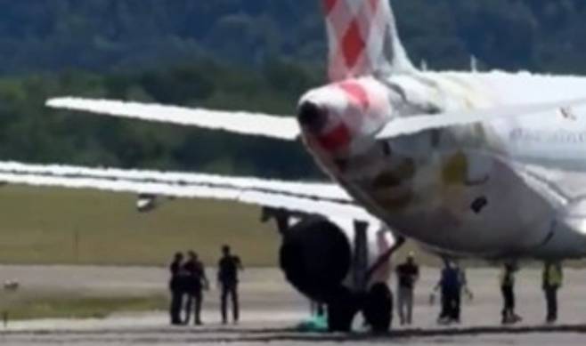 사건이 발생한 여객기 엔진 주위로 공항 관계자들이 모여있다. 엑스 캡처