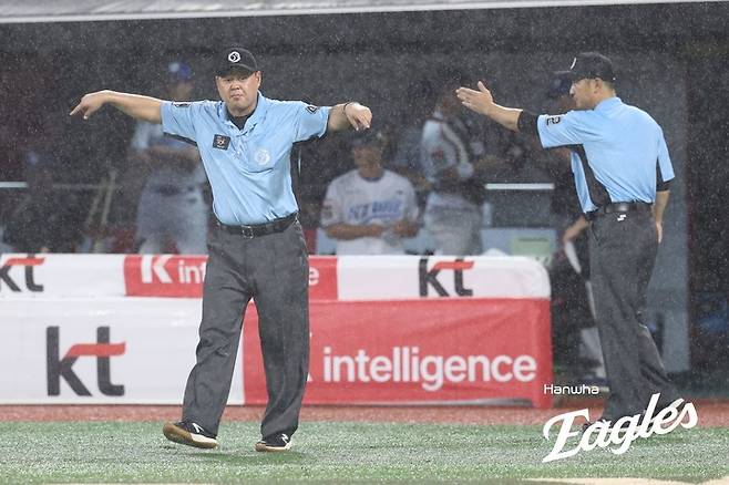 19일 수원 KT위즈파크에서 열린 한화 이글스와 KT 위즈의 경기 도중 비가 쏟아지자 우천 중단을 선언하는 심판진