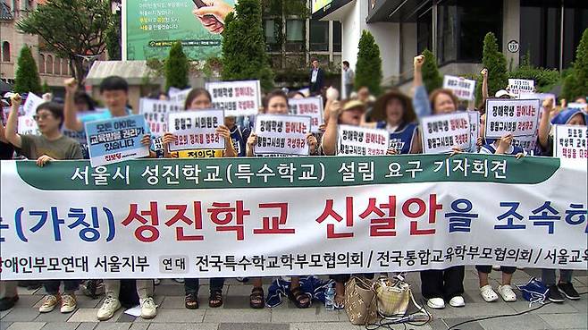 전국장애인부모연대 서울지부 등이 27일 서울 중구 서울시의회 인근에서 연 '성진학교 설립 촉구' 기자회견에서 참가자들이 특수학교 설립을 촉구하는 손팻말을 들고 있다.