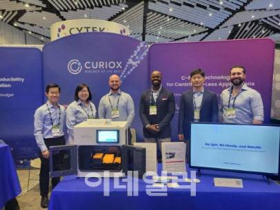 At Cyto2025, Curiox CEO Namyong Kim (second from right) and others showcase Curiox’s products. (Photo=Curiox)