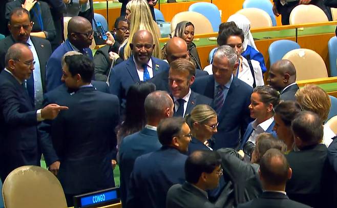 에마뉘엘 마크롱 프랑스 대통령(가운데)이 22일 미국 뉴욕 유엔 본부에 입장하며 많은 참석자들로부터 환대를 받았다./유엔