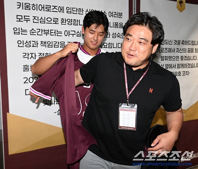 24일 고척스카이돔에서 열린 KIA와 키움의 경기, 경기 전 진행된 키움 히어로즈의 2026 신인선수 환영행사에서 1라운드 전체 1순위로 키움에 입단한 박준현이 아버지 박석민 전 코치에게 자신의 첫 친필 사인이 담긴 유니폼을 선물하며 유니폼을 입혀주고 있다. 고척=허상욱 기자wook@sportschosun.com/2025.09.24/
