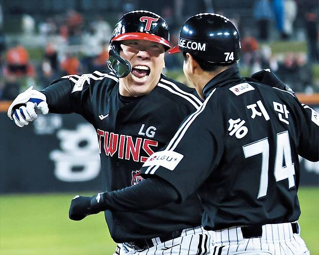 LG 김현수가 30일 한화와 벌인 프로야구 한국시리즈 4차전에서 9회 초 역전 2타점 적시타를 때려낸 뒤 송지만 코치와 기쁨을 나누고 있다./연합뉴스